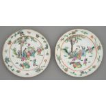 Two Chinese famille rose plates, late 19th c, painted with a lady at a table attended by seven young