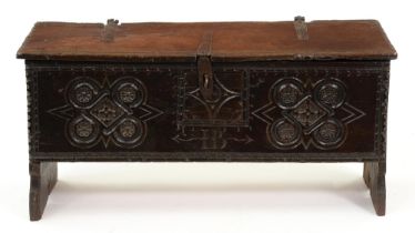 A Charles II oak chest, the front carved with the initials IB flanked by four flower roundels in