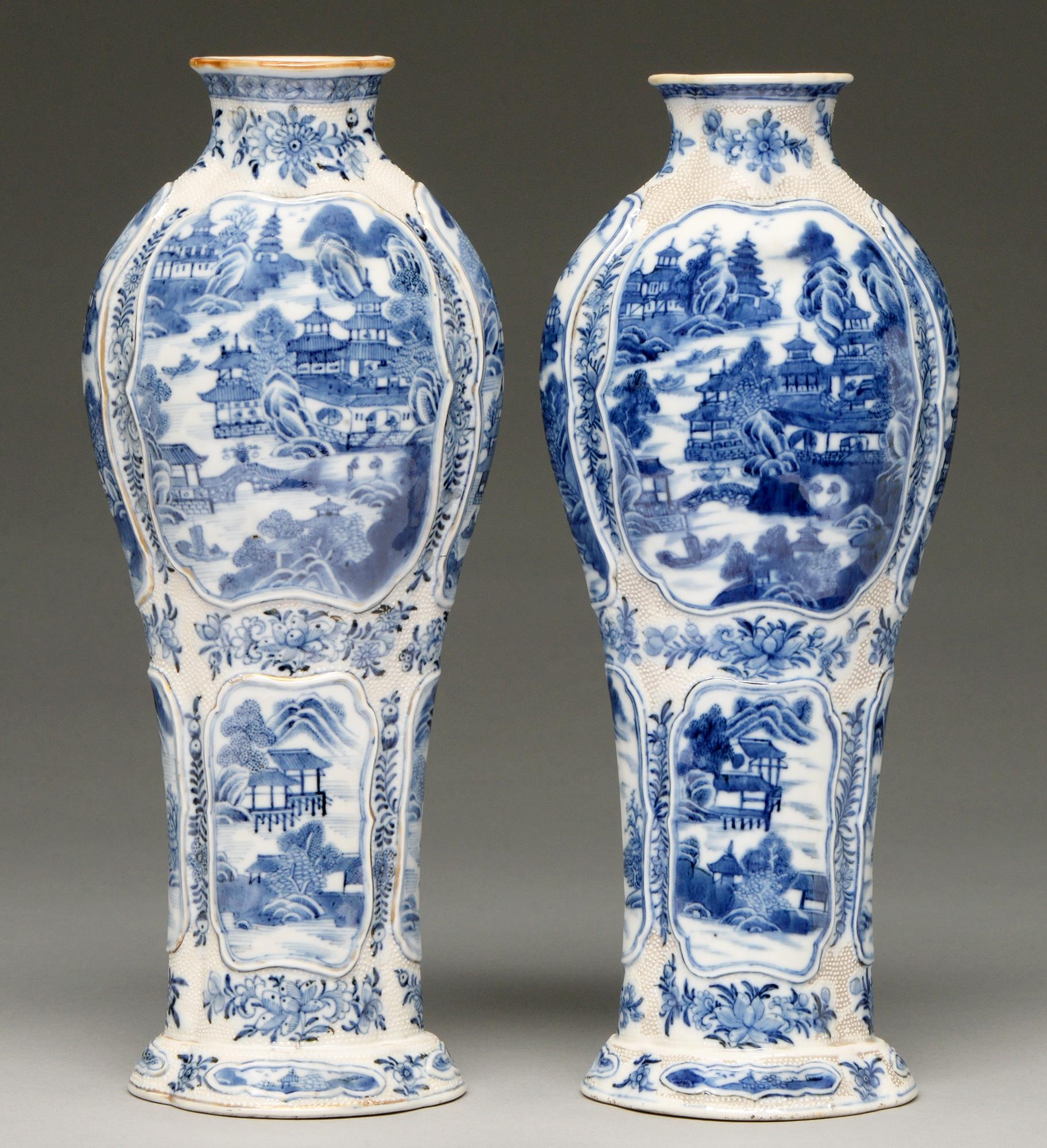 A pair of Chinese blue and white waisted baluster vases, late 18th c, painted with landscapes in