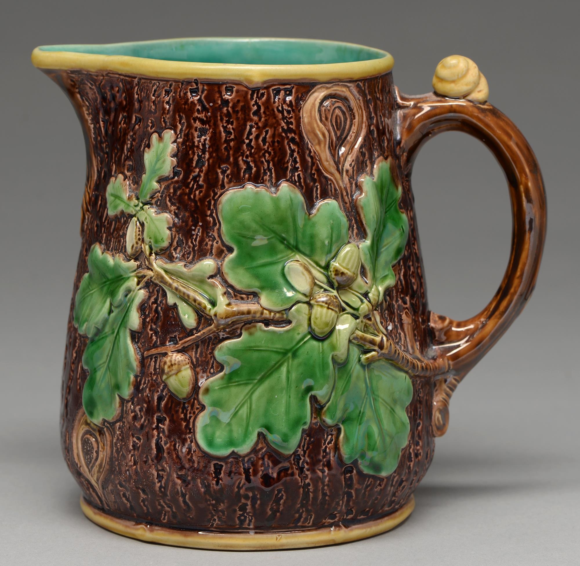 A Minton majolica rustic jug, 1866, moulded with oak leaves and acorns, the handle with a snail