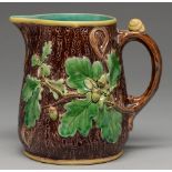 A Minton majolica rustic jug, 1866, moulded with oak leaves and acorns, the handle with a snail