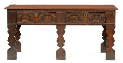 A William III oak dresser, the two plank top with ovolo lip above two geometrically moulded drawers,