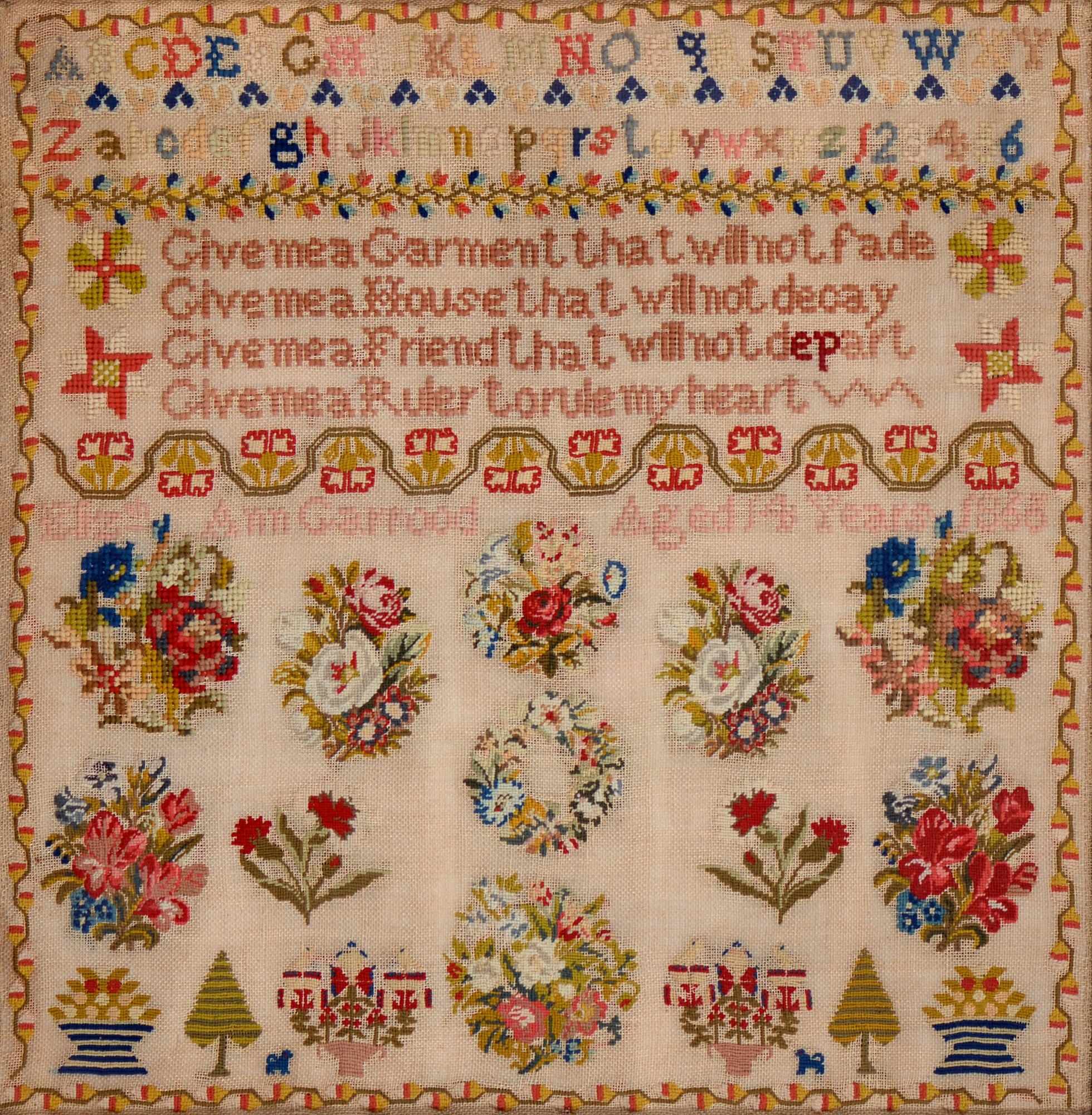 A Victorian linen sampler, Elizabeth Ann Garrood aged 14 years 1866, worked in brightly coloured