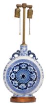 A blue and white porcelain moon flask adapted as a table lamp, the porcelain c1900, painted in