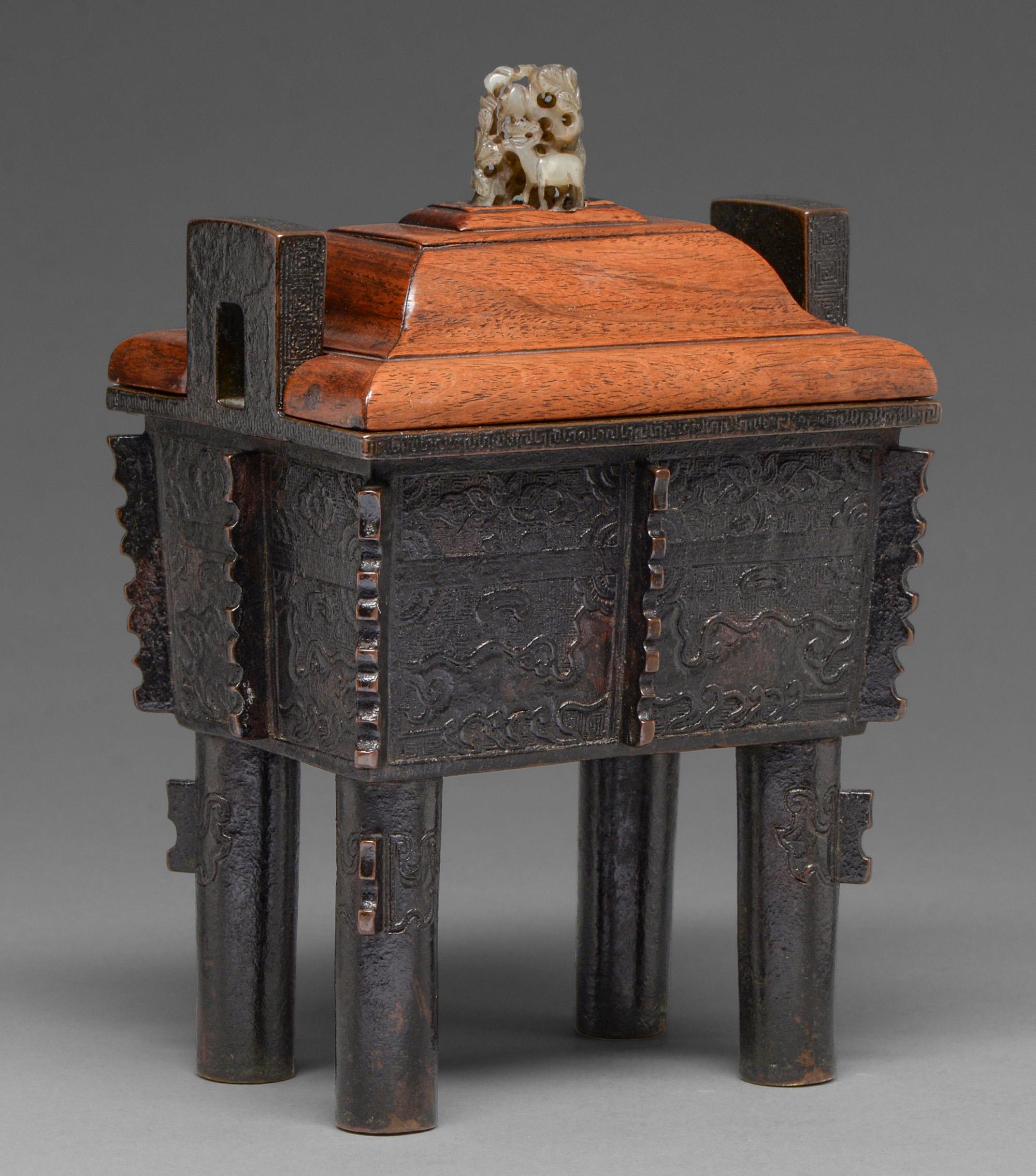 A Chinese bronze archaistic censer, Fang Ding, 17th / 18th c and a Chinese wood cover, the