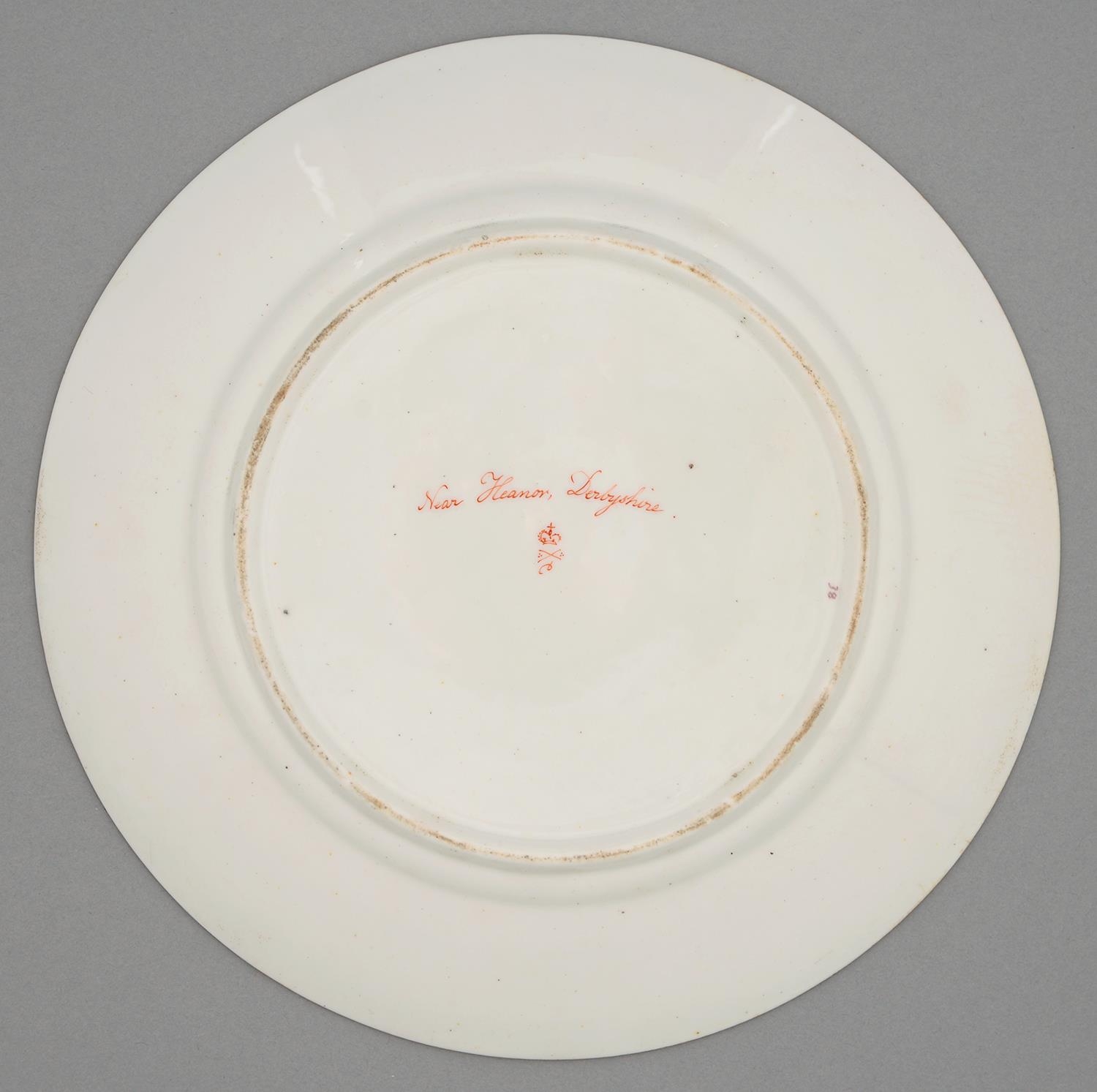 A Derby plate, c1820, painted with a landscape with a horseman and peasant in gilt anthemia - Image 2 of 2