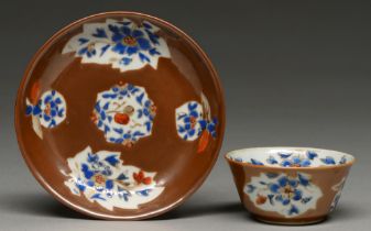 A Chinese Batavian ware tea bowl and saucer, 18th c, enamelled and gilt with leaf or fruit shaped