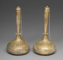 A pair of brass flasks and chained stoppers, North India, 19th c, chased with foliage, the onion