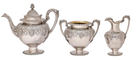 A Scottish Victorian silver tea service, of vase shape and embossed with grapevines in egg-and-