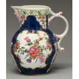 A Worcester scale blue ground cabbage leaf mask jug, c1770, painted in bright enamels with