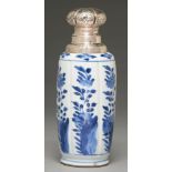 A Chinese blue and white vase, Kangxi period, painted with fruiting or flowering plants growing from