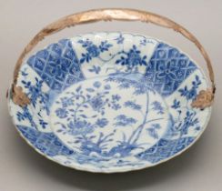 A Chinese blue and white dish, Kangxi period, painted with peony and bamboo sprouting from hollow