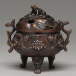 A Chinese bronze tripod censer, 20th c, cast with lotus, the domed cover with toad finial, on