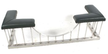 A contemporary Club fender. Brushed (burnished) steel base with green leather padded seats.