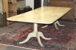 A contemporary extending Regency style twin pillar dining table.