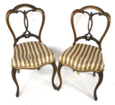 A Pair of early Victorian walnut overstuffed balloon back chairs.