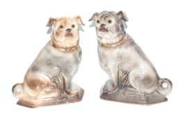 A pair of Victorian Staffordshire earthenware models of pug dogs.