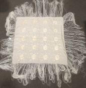 A 20th century cream silk embroidered shawl.