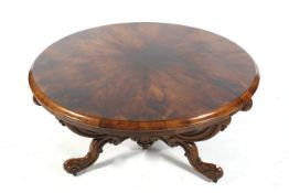 A Victorian Rosewood circular table with three cabriole legs and scrolled supports,