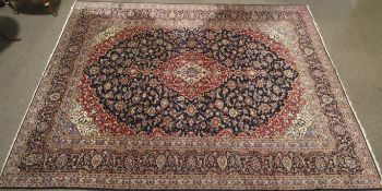 A mid-late 20 th century Persian hand woven Woollen carpet.