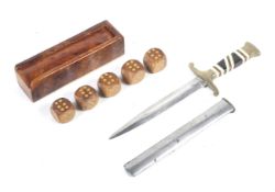 A 20th century dagger and a boxed set of dice.