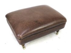 A modern oblong leather pouffe.