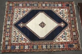 An unusual early to mid 20 the century Persian style hand woven woollen rug.