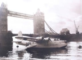 A print of a flying boat plane by Tower Bridge.