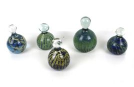 Five Maltese glass paperweights.