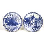 A pair of large Delft blue and white chargers. Both decorated with working horses.