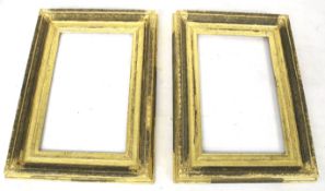 A pair of antique gilt wooden picture frames.