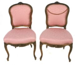 A pair of 19th century walnut Louis XV style single chairs.