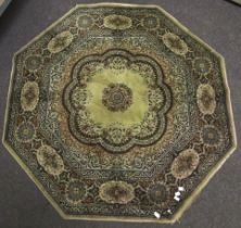 A 1970's machine woven Persian style hexagonal rug. In a green, blue and brown colour palette, etc.