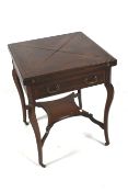 An Edwardian strung inlaid mahogany envelope topped fold out card table.
