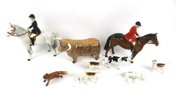 A set of vintage Beswick fox hunting figures, a bull and a calf.