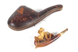A late 19th/early 20th century meershaum pipe carved with a horse trampling a snake.