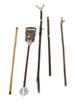 Four walking sticks and a shooting stick.