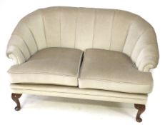 A contemporary two seater tub shaped settee.