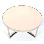 A contemporary chrome framed circular coffee table. With a copper mirror glass top.