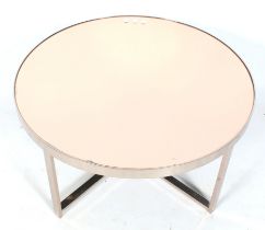 A contemporary chrome framed circular coffee table. With a copper mirror glass top.