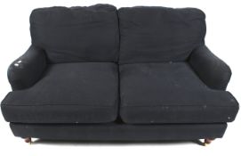 A contemporary Howard style double seat sofa in navy blue upholstery.