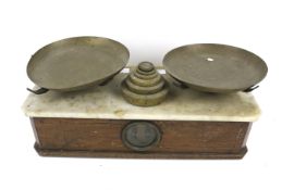 A set of marble top balance scales.