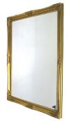 A contemporary gilt framed bevelled edge wall mirror.