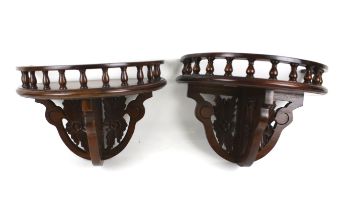 A pair of reproduction mahogany wall brackets.