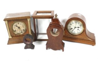 A collection of assorted clocks and parts. Including two mantel clocks and three clock cases.