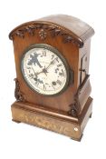 A Victorian 8 day walnut cased mantel clock with painted dial.