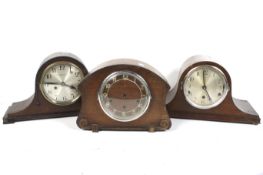Three vintage oak cased mantle clocks. Including a Northern Goldsmiths Co.