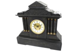 A 19th century black marble mantel clock. Striking to a gong.