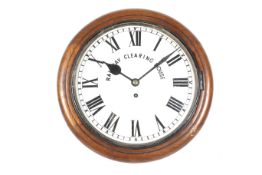 A vintage circular wall clock 'Railway Clearing House'. A mahogany cased fusee wall clock.
