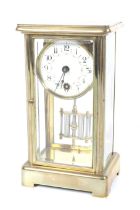 A small four glass brass cased mantel clock. A white dial with floral swags, Arabic numerals.
